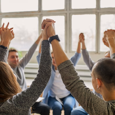 Support Group Holding Hands in a Holistic Addiction Recovery Session