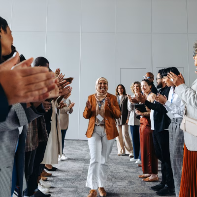 Confident Woman Walking Through Applauding Crowd, Symbolizing Self-Empowerment and Motivation